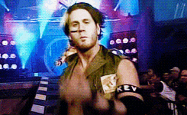 a wrestler wearing a green vest with the word key on it