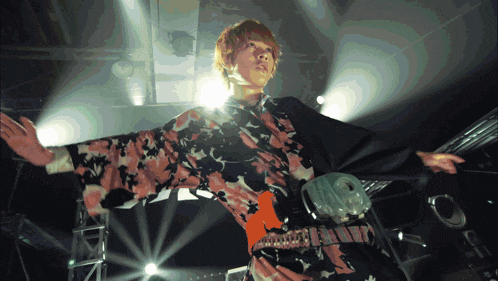 a woman in a kimono is dancing on stage
