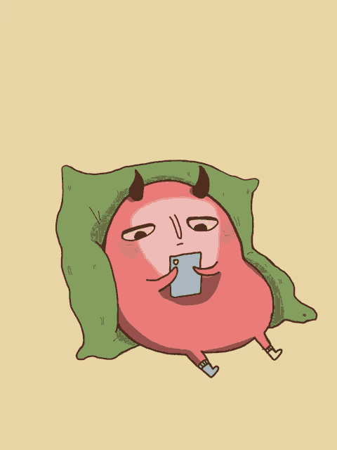 a cartoon character with horns is laying on a green pillow and looking at a cell phone