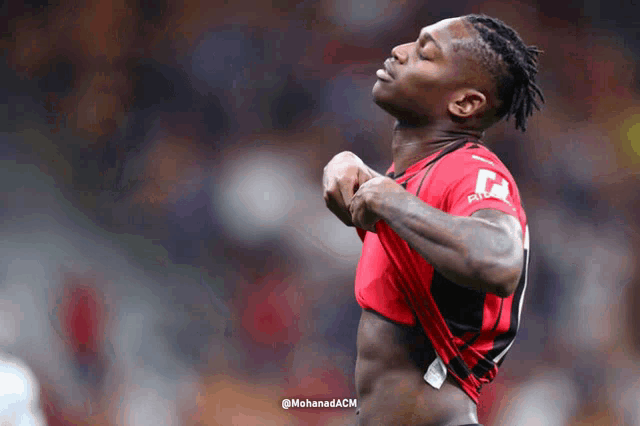a soccer player is taking off his shirt with the hashtag @mohanadacm