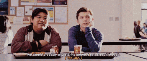 two men are sitting at a table in a cafeteria and one of them is talking about staring before it gets creepy