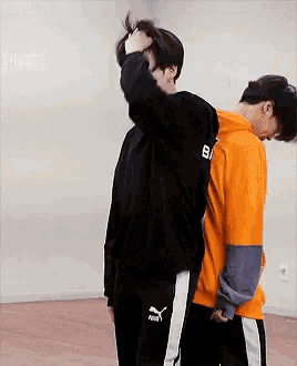 a man wearing a black hoodie with the number 8 on it