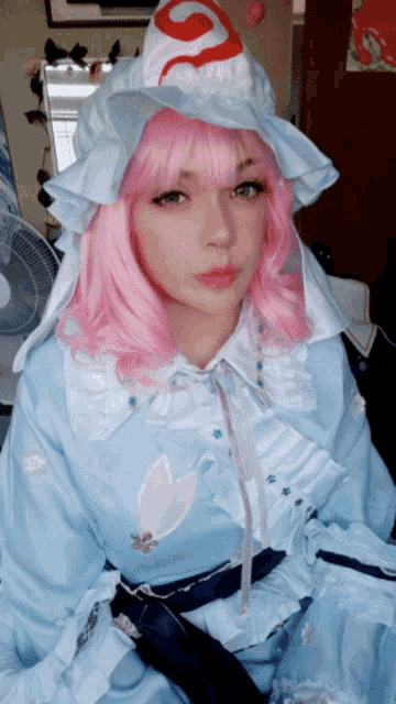 a girl with pink hair and a white hat is wearing a blue dress