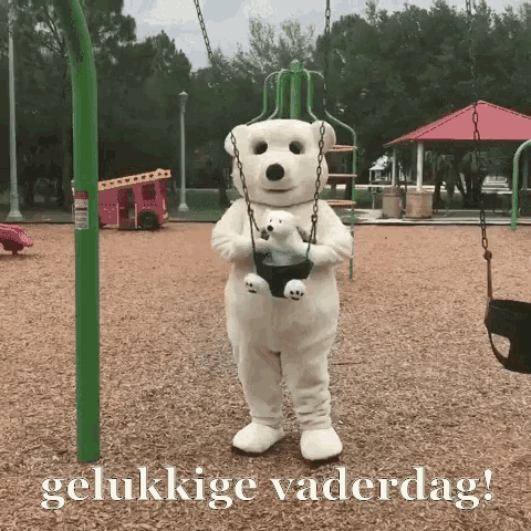 a polar bear mascot is holding a teddy bear on a swing in a playground .