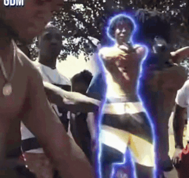 a shirtless man is standing in front of a group of people with the word odm on the bottom right corner