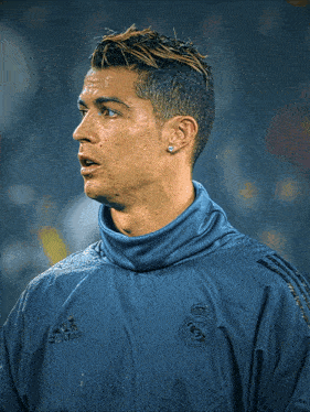 a soccer player wearing a blue adidas jacket