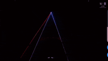 a spotlight is shining on a person in a dark room with the letters n on the bottom