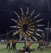 a large ferris wheel is on a field with a sign that says we dream world