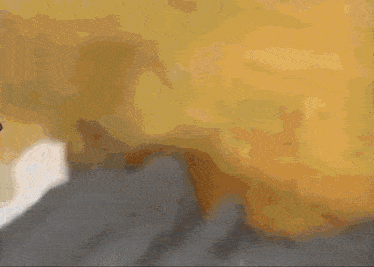 a blurred image of a wall with a window visible