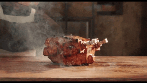 a piece of meat is being cooked on a cutting board