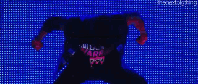 a person is standing in front of a screen with a lot of lights on it .