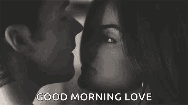 a black and white photo of a man and woman kissing with the words `` good morning love '' below them .