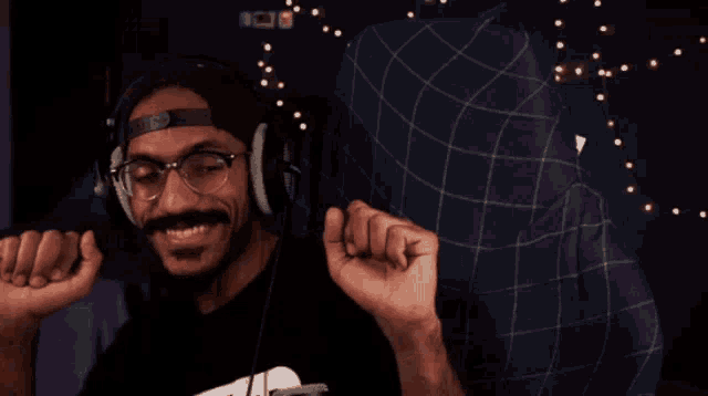 a man wearing headphones and a headband that says ' snoop dogg ' on it