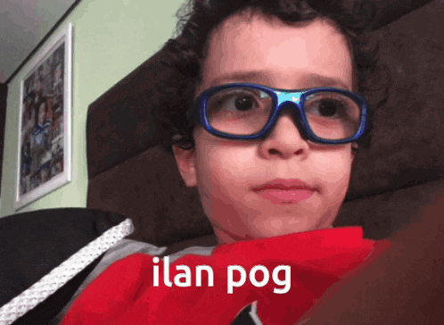 a young boy wearing glasses and a red tie says ilan pog on the bottom