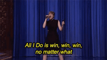 a woman singing into a microphone with the words all i do is win win win no matter what