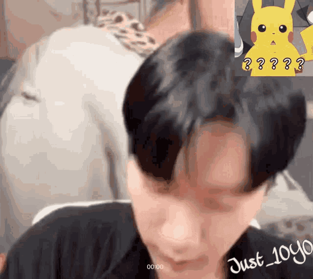 a man with a pikachu sticker on his forehead