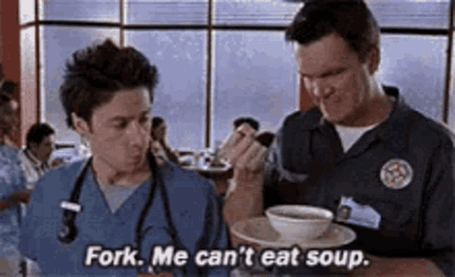 two men are sitting at a table with a bowl of soup .