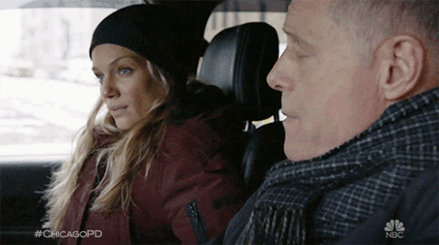 a man and a woman in a car with #chicagopd on the bottom right