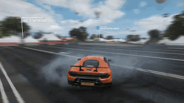 an orange sports car is driving down a road with the words fast is important on the bottom