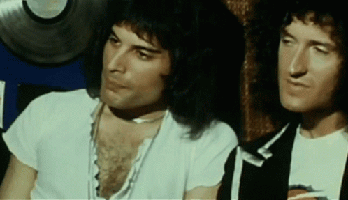 Queen Freddie Mercury GIF - Queen Freddie Mercury Touch Chest GIFs