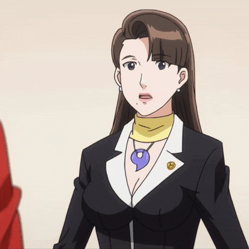 a woman in a suit has a yellow scarf around her neck and a purple necklace