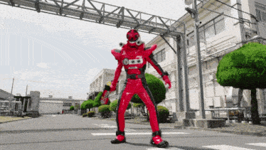 a man in a red and black costume holds a coca cola can