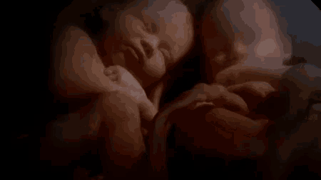 a couple of babies sleeping next to each other with the words selamat ya written above them .