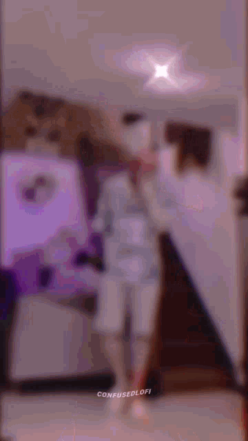 a man in a spiderman costume is dancing in a room