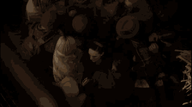 a group of people are gathered together in a dark room