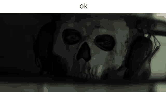 a skull with headphones is visible through a rear view mirror