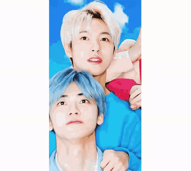 two young men with blue hair are posing for a picture and one of them is making a funny face .