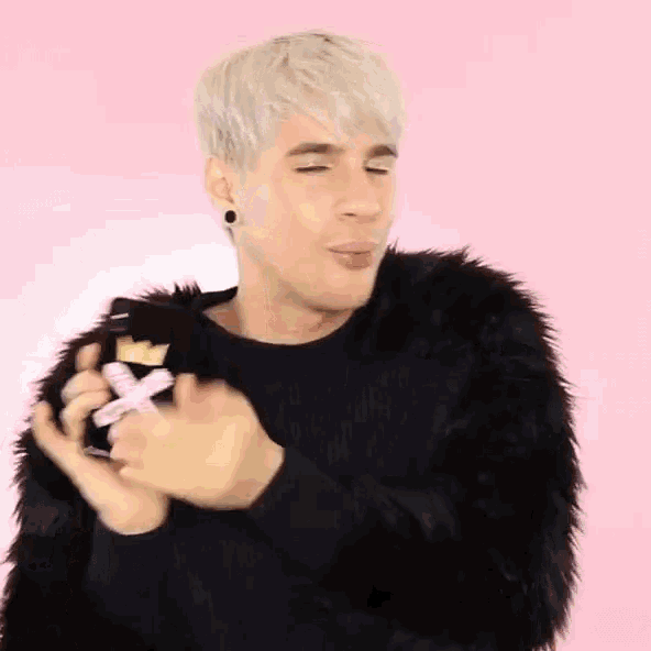 a man in a fur coat is holding a bottle of perfume .