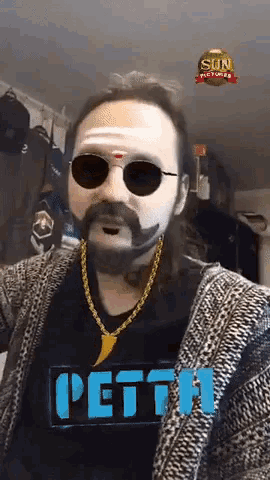 a man wearing sunglasses and a shirt that says petth