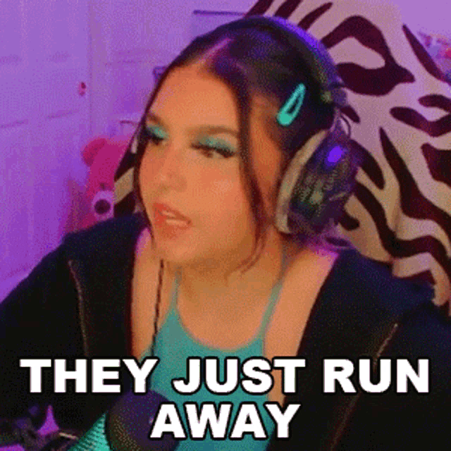 a woman wearing headphones says " they just run away " in front of a microphone