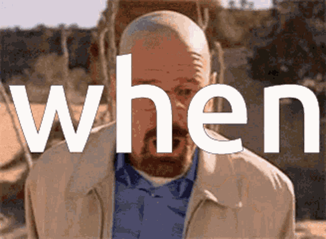 a man with a beard is standing in front of a sign that says when