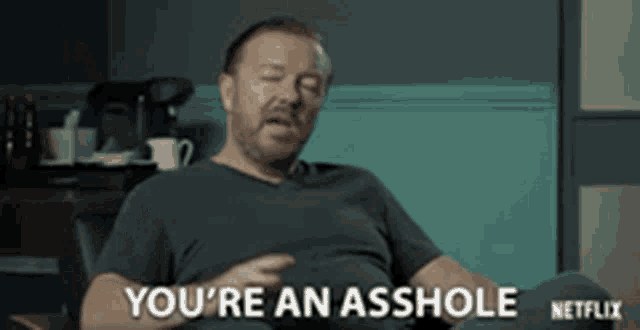 a man is sitting in a chair with his eyes closed and says you 're an asshole .