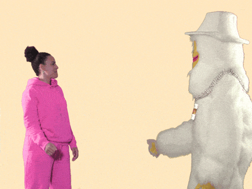 a woman in a pink hoodie gives a high five to a white mascot wearing a chain with the letter z on it
