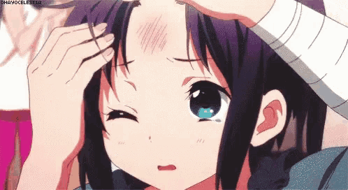 a close up of a person touching a girl 's forehead with a bandage .