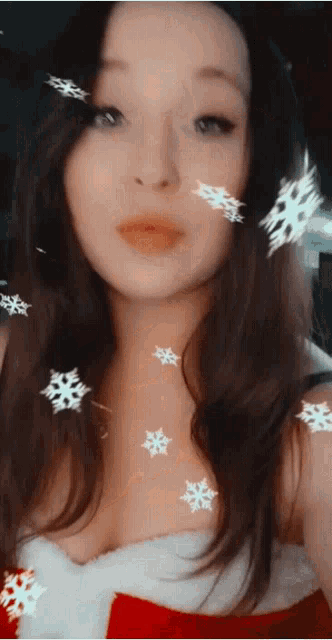 a woman with snowflakes on her face is wearing a santa dress
