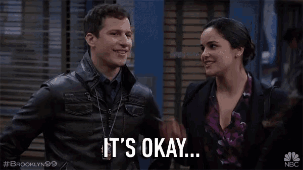 a man and a woman are standing next to each other and the woman is saying it 's okay