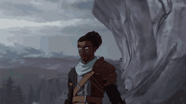 a man with a beard and a scarf around his neck stands in front of a mountain