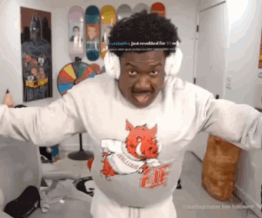 a man wearing a shirt with a pig on it