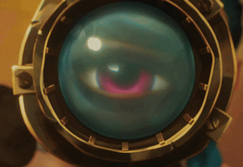 a woman looks through a telescope with a blue lens