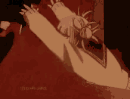 a person is laying on the floor with their arms outstretched and a red background .