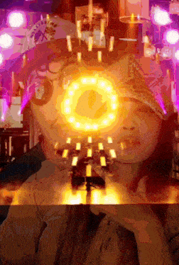a collage of a woman 's face with a circle of lights behind her