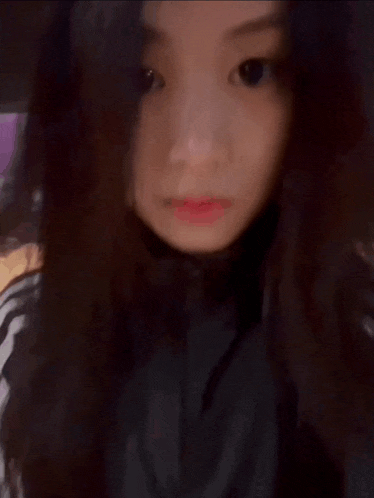a close up of a woman 's face with a blurred background