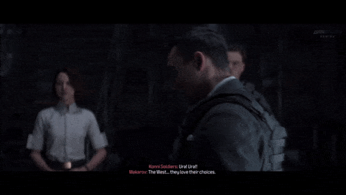 a man in a suit is talking to a woman and another man
