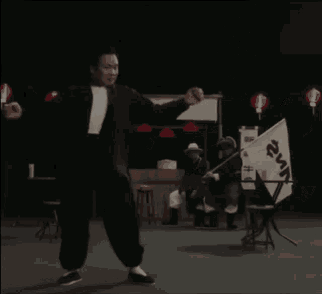 a man is dancing in front of a sign that says ' chinese ' on it