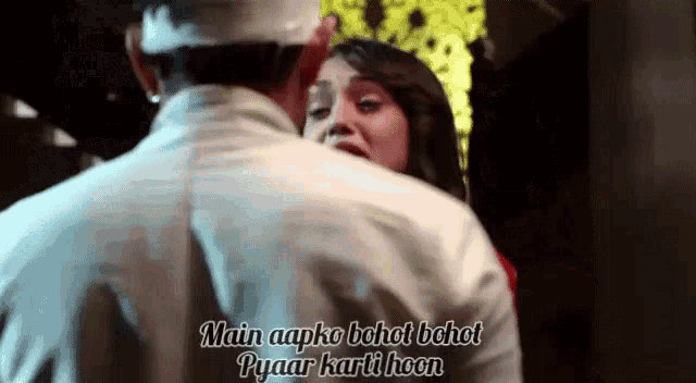 a man is hugging a woman with the words main aapko bohot bohot pyaar karti hoon .