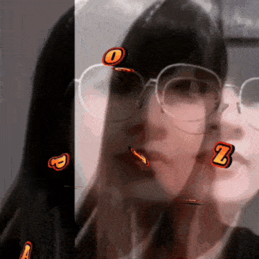a woman wearing glasses has a sticker that says z on her face
